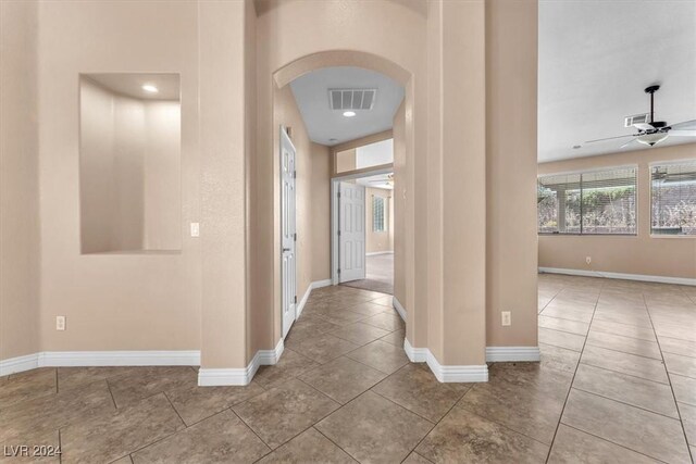 3689 Callahan Ave, Las Vegas, NV 89120 - hallway featuring arched walkways, baseboards, and tile patterned flooring