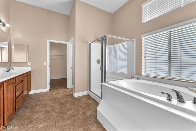 bathroom featuring tile patterned flooring, vanity, and independent shower and bath