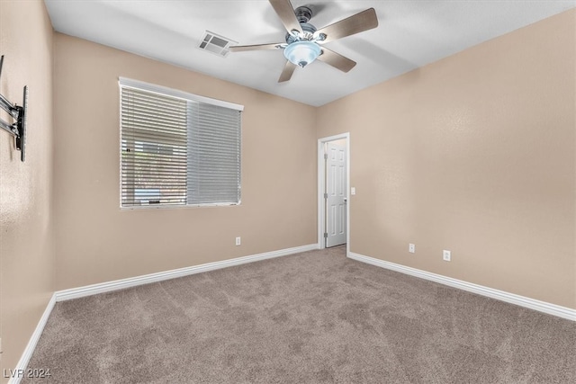 spare room featuring carpet floors and ceiling fan