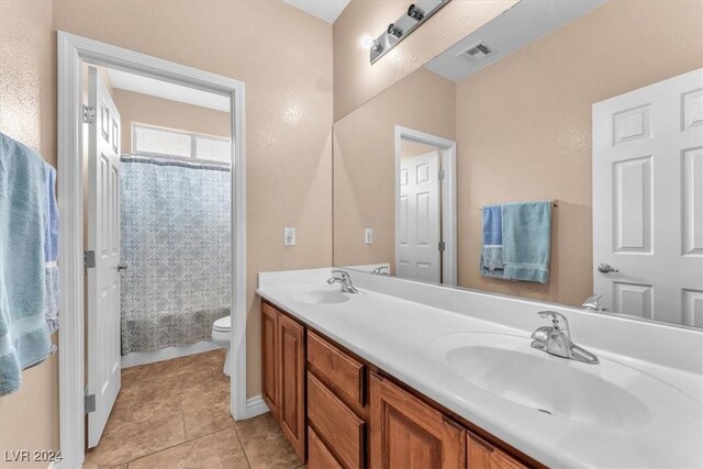 3689 Callahan Ave, Las Vegas, NV 89120 - bathroom with toilet, double vanity, tile patterned floors, and shower / bath combo with shower curtain