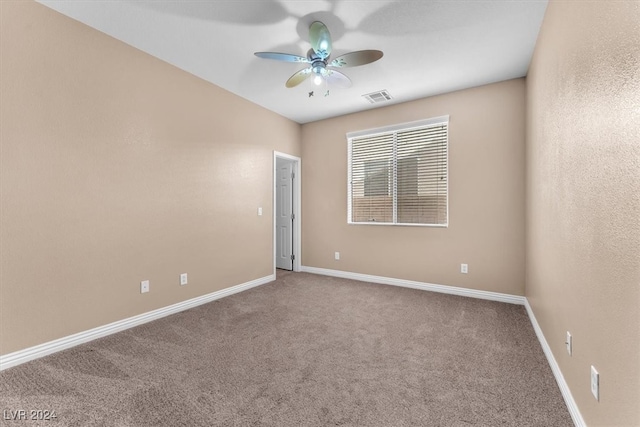 spare room with carpet and ceiling fan