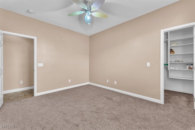 unfurnished bedroom featuring ceiling fan, a closet, and carpet flooring