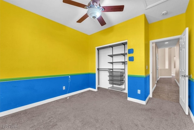 interior space featuring ceiling fan and carpet flooring