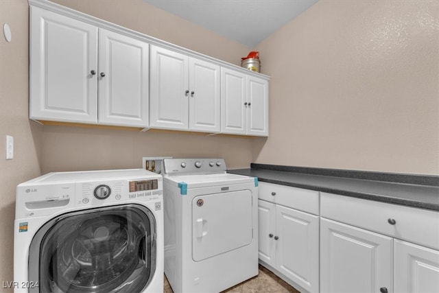 laundry area featuring washer and dryer and cabinets