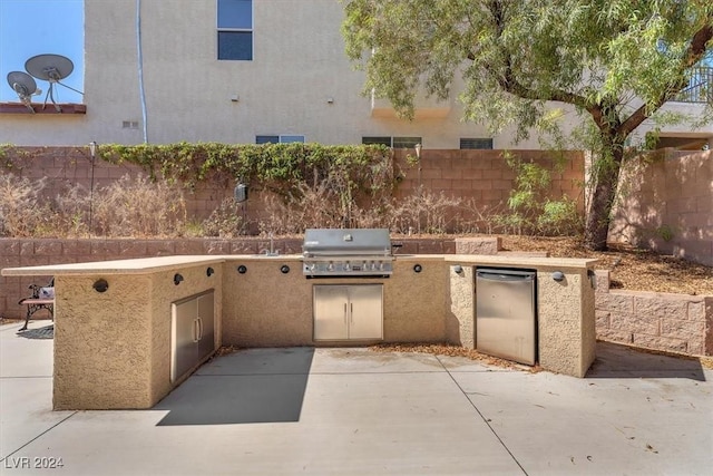 3689 Callahan Ave, Las Vegas, NV 89120 - view of patio with exterior kitchen, grilling area, and fence