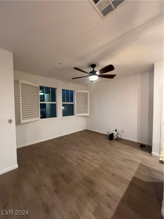 empty room with ceiling fan and wood-type flooring