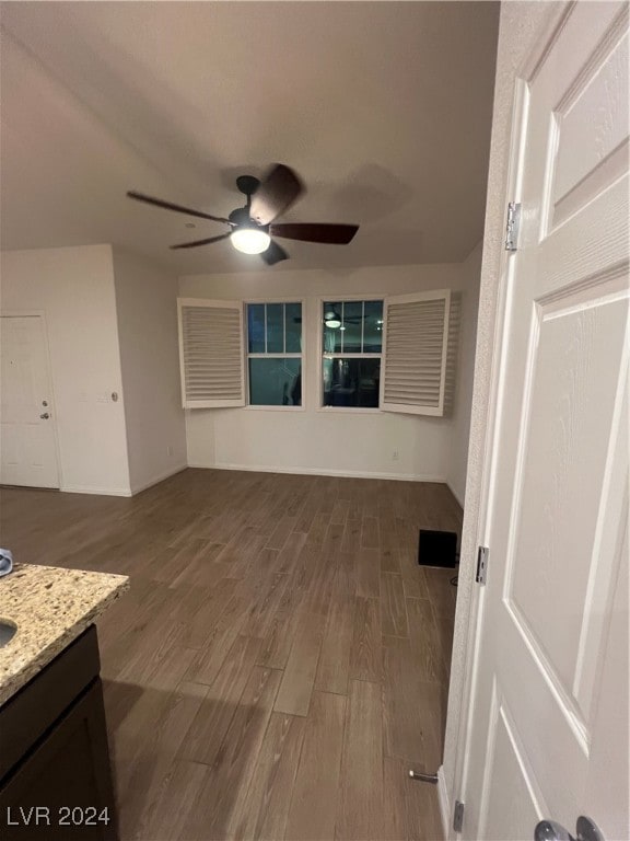 unfurnished living room with hardwood / wood-style flooring and ceiling fan