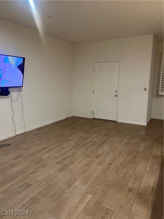 unfurnished living room with hardwood / wood-style flooring