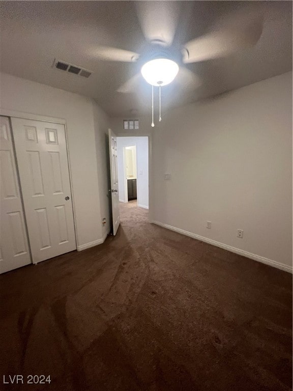 carpeted empty room featuring a textured ceiling and ceiling fan