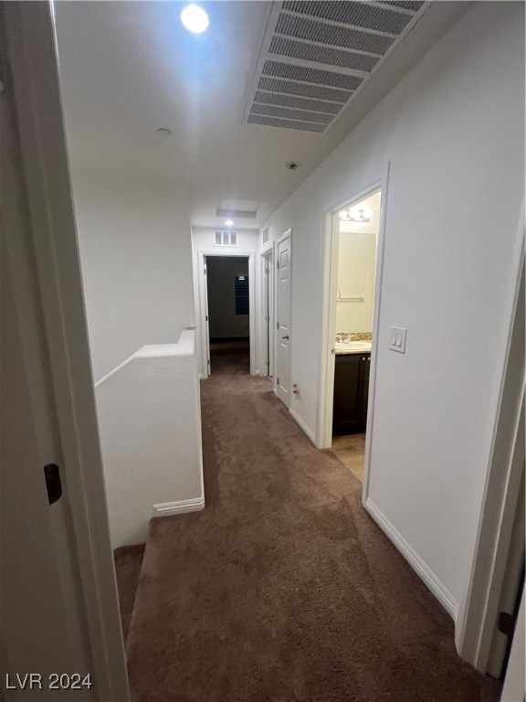 hallway with carpet floors