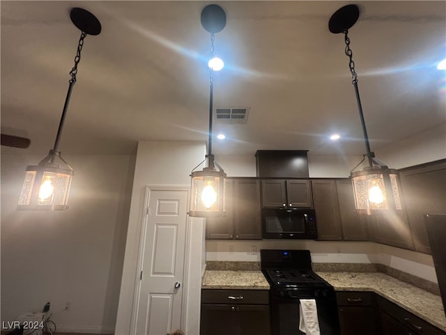 kitchen with light stone counters, dark brown cabinets, black appliances, and decorative light fixtures