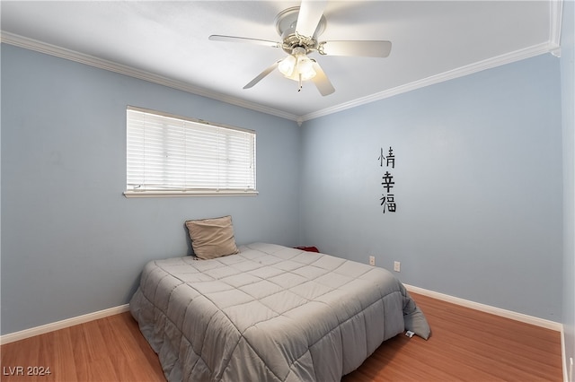 bedroom featuring ceiling fan, ornamental molding, and wood-type flooring