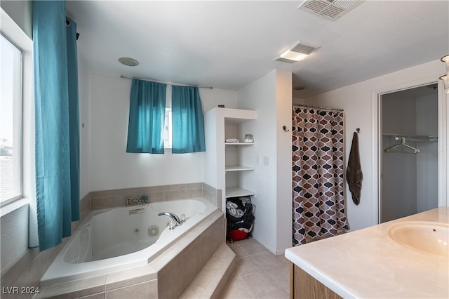 bathroom featuring independent shower and bath, tile patterned floors, vanity, and a healthy amount of sunlight