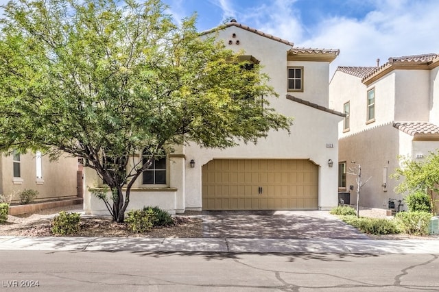 mediterranean / spanish-style house featuring a garage