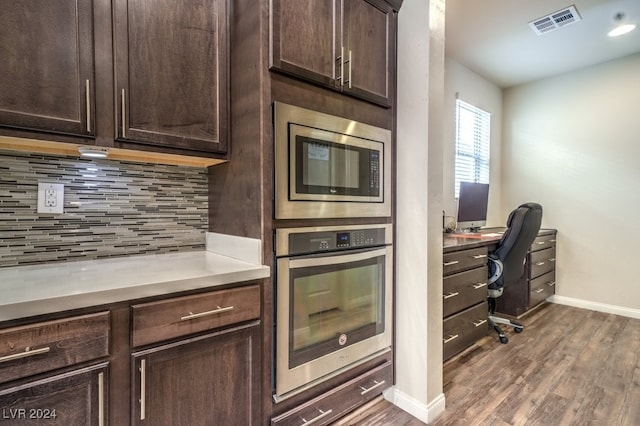 kitchen with dark brown cabinets, backsplash, stainless steel appliances, and dark hardwood / wood-style floors