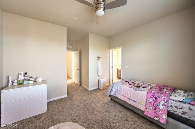 carpeted bedroom with ceiling fan and ensuite bath