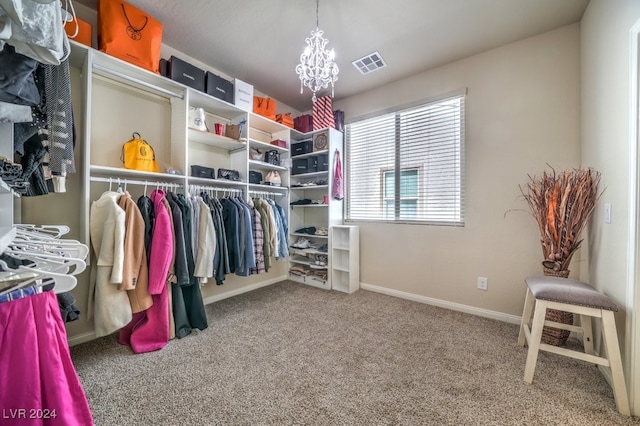 spacious closet with carpet floors and a notable chandelier