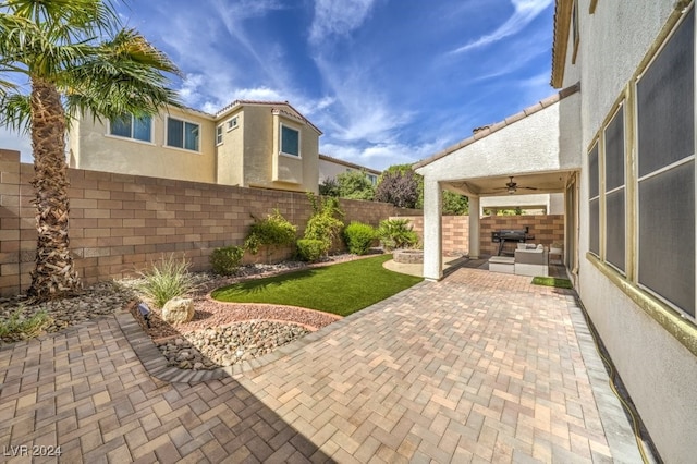 view of patio with a grill and ceiling fan