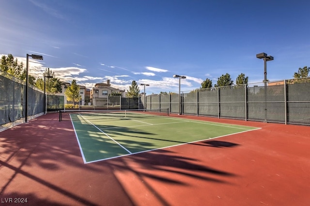 view of tennis court featuring basketball hoop