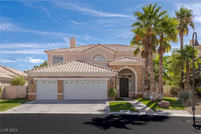 mediterranean / spanish house featuring a garage