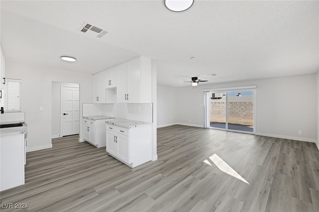 kitchen featuring light hardwood / wood-style floors, white cabinetry, and plenty of natural light