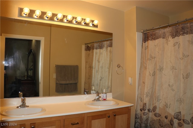 bathroom featuring vanity and a shower with shower curtain