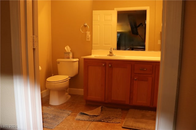 bathroom featuring tile patterned flooring, vanity, and toilet