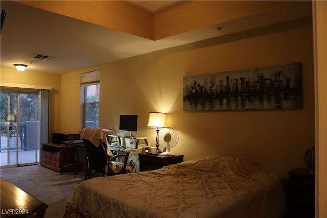 bedroom featuring access to exterior and carpet floors