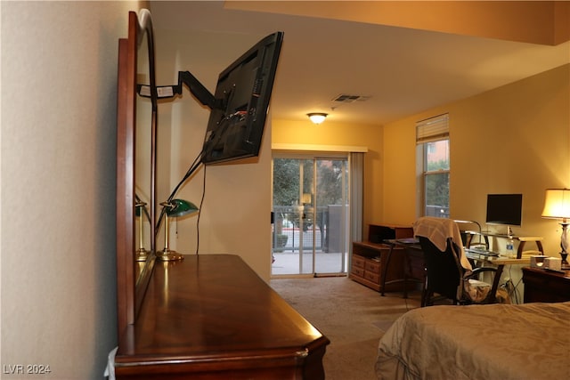 bedroom featuring light carpet and access to outside