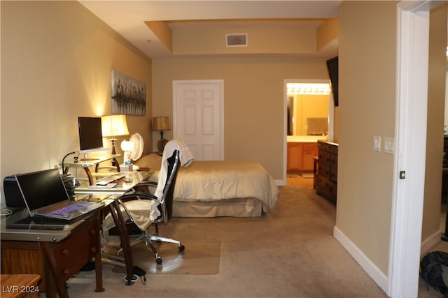 carpeted bedroom featuring ensuite bath