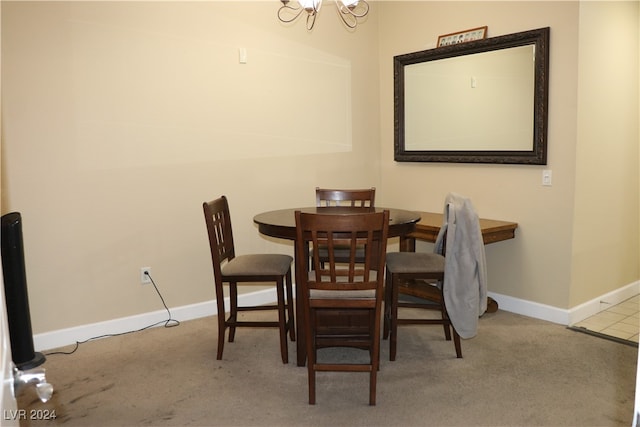 dining room featuring a chandelier and light carpet