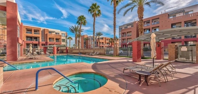 view of swimming pool featuring a community hot tub and a patio area