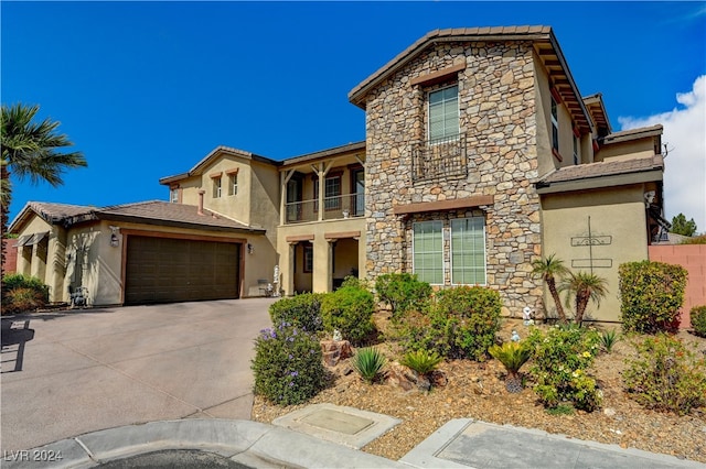 view of front of house featuring a balcony and a garage