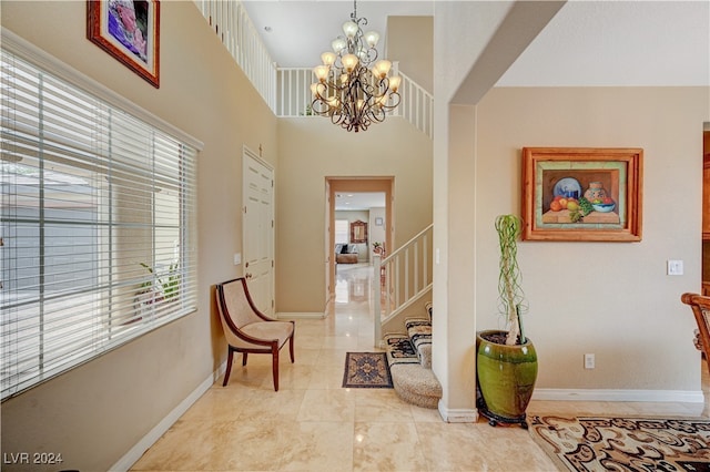 hall featuring a chandelier and a high ceiling