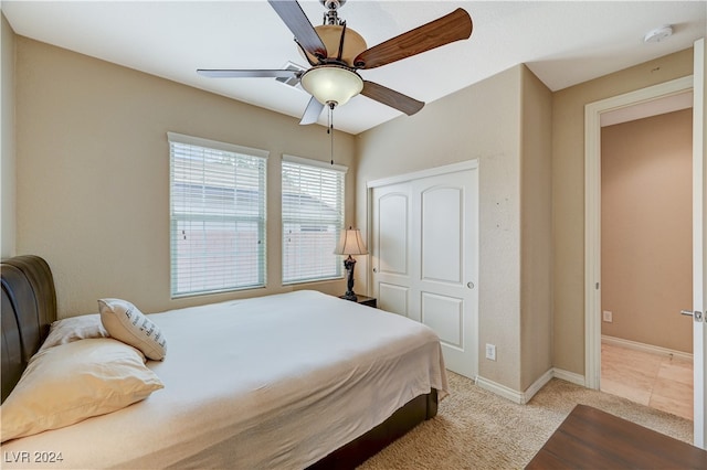 carpeted bedroom featuring a closet and ceiling fan