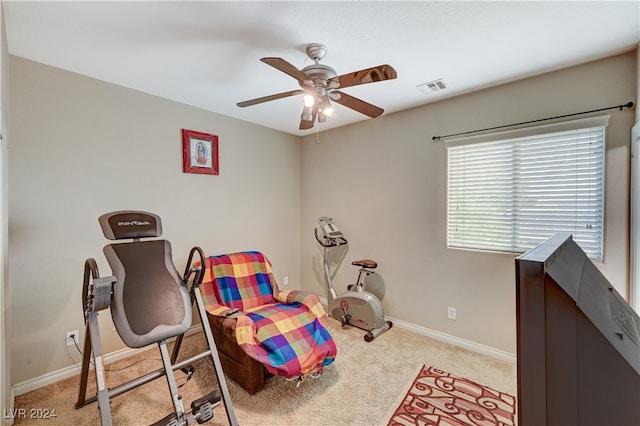 interior space featuring ceiling fan and light colored carpet