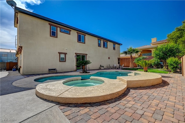 view of pool featuring an in ground hot tub and a patio