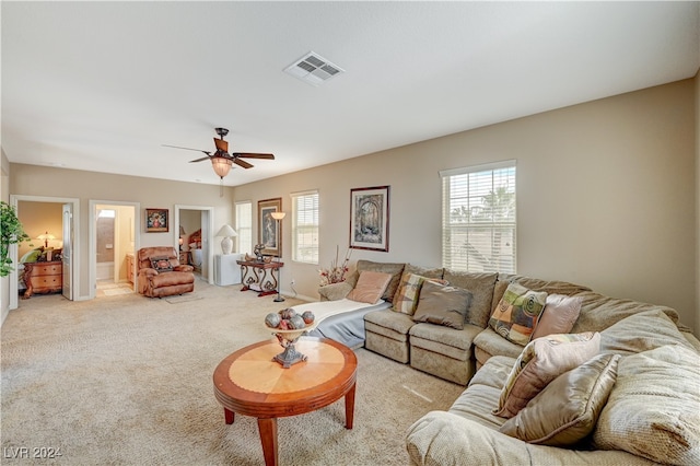 living room featuring light colored carpet and ceiling fan