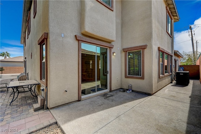 rear view of property with a patio and central air condition unit