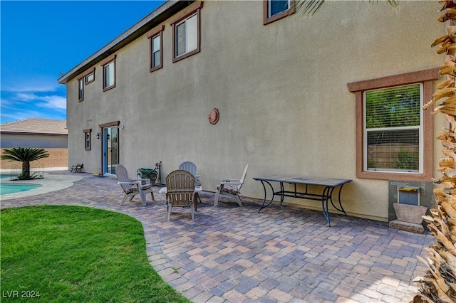 back of house featuring a lawn and a patio