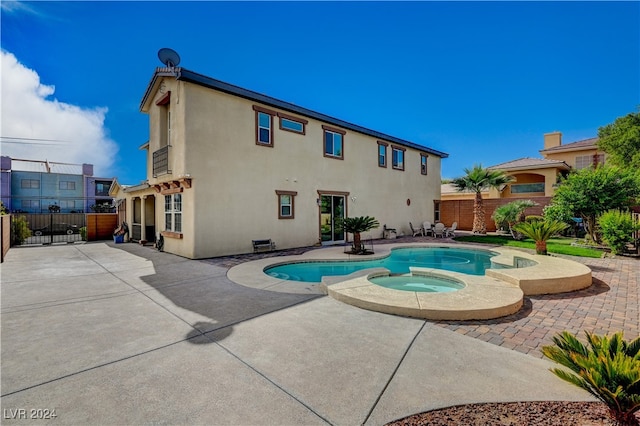 view of swimming pool with an in ground hot tub and a patio