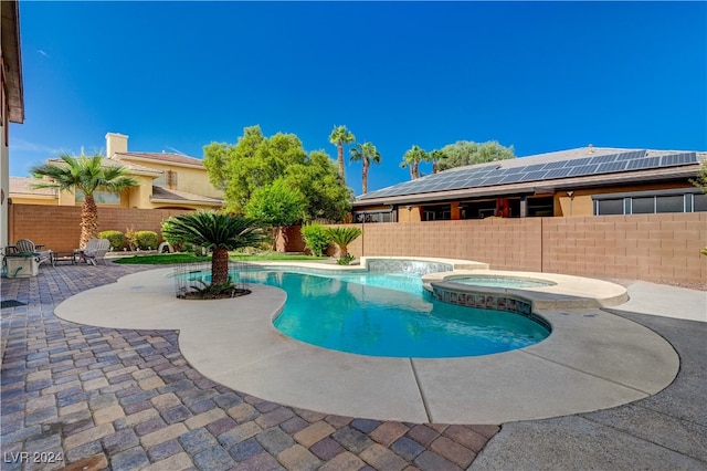 view of pool with an in ground hot tub and a patio area