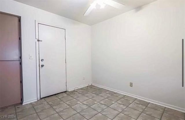 unfurnished room featuring a ceiling fan and baseboards