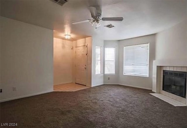 unfurnished living room featuring visible vents, carpet floors, ceiling fan, and a fireplace