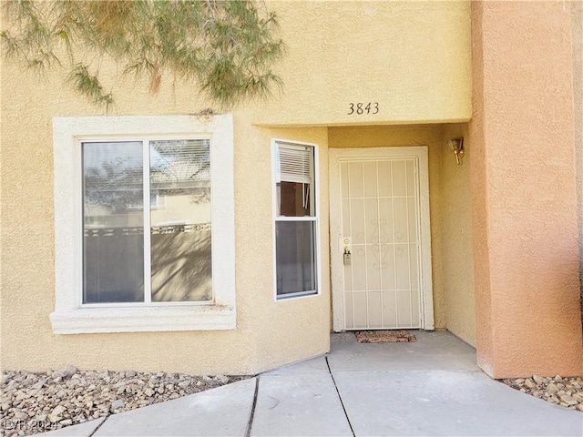 doorway to property with stucco siding