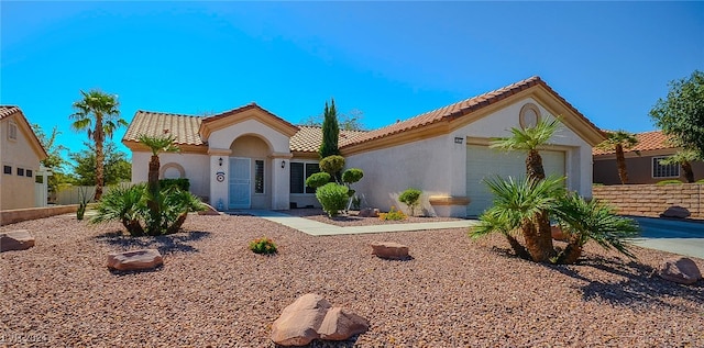 mediterranean / spanish house with a garage