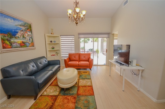 living room with vaulted ceiling, a chandelier, and wood-type flooring