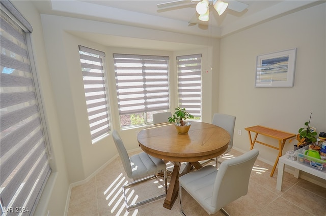 dining area featuring ceiling fan and light tile patterned floors