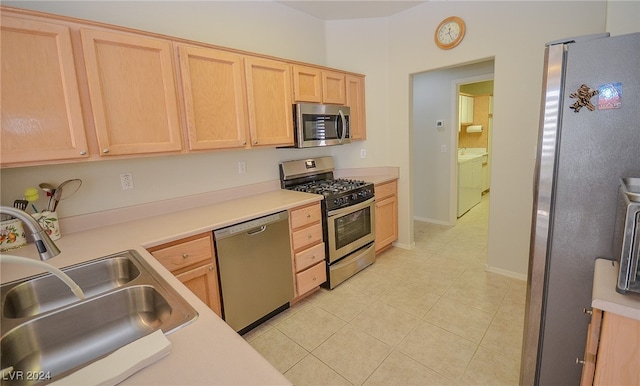 kitchen with light brown cabinetry, appliances with stainless steel finishes, sink, and light tile patterned floors