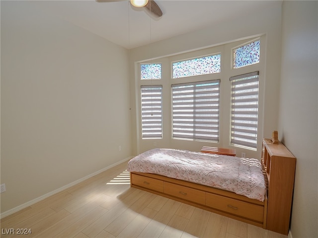 bedroom with ceiling fan and light hardwood / wood-style floors